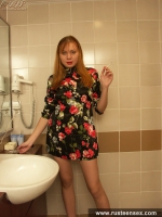 Teen redhead poses naked in the toilet