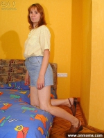 Mature shy woman undresses on the bed