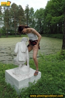 Teen pissing outdoor on a statue