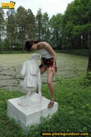 Teen pissing outdoor on a statue