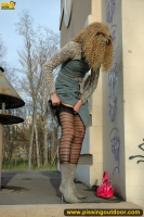 Outdoor pissing near graffiti