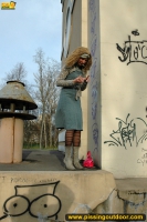 Outdoor pissing near graffiti