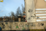 Outdoor pissing near graffiti