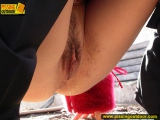 Teen brunette outdoor pissing in a suburb street