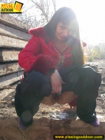 Teen brunette outdoor pissing in a suburb street