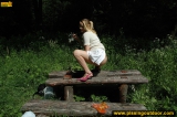 Pissing outdoor deep in the forest on the old table