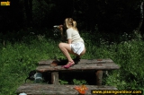Pissing outdoor deep in the forest on the old table