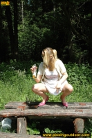 Pissing outdoor deep in the forest on the old table