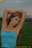 Pissing outdoor in the evening grass field