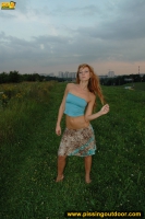 Pissing outdoor in the evening grass field
