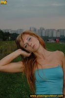 Pissing outdoor in the evening grass field