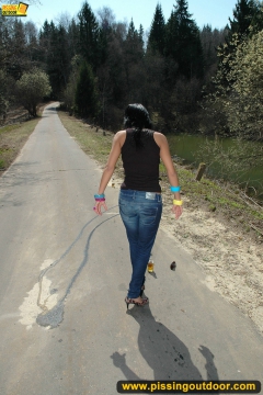 Teen brunette pissing on asphalt path outdoor - N