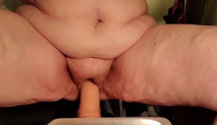 Brandy riding her toy.Front view - N