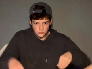 Redheaded teenager in a hoodie jerking off
